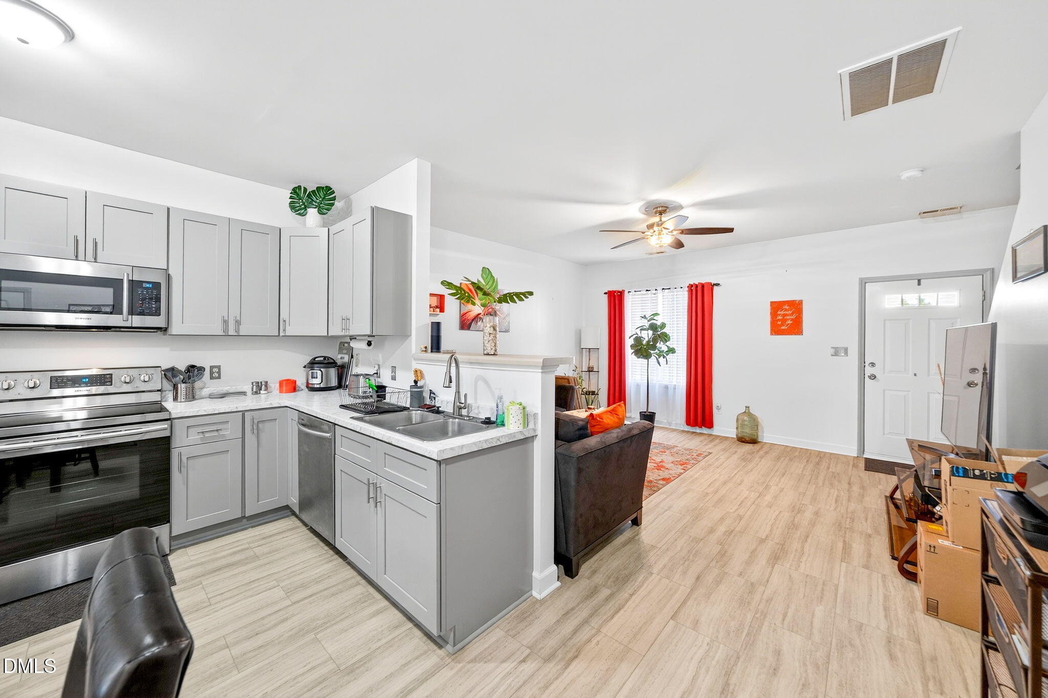 6010 San Marcos Way Raleigh, NC 27616 - Photo 7 of 22 a kitchen with a stove a sink and a refrigerator