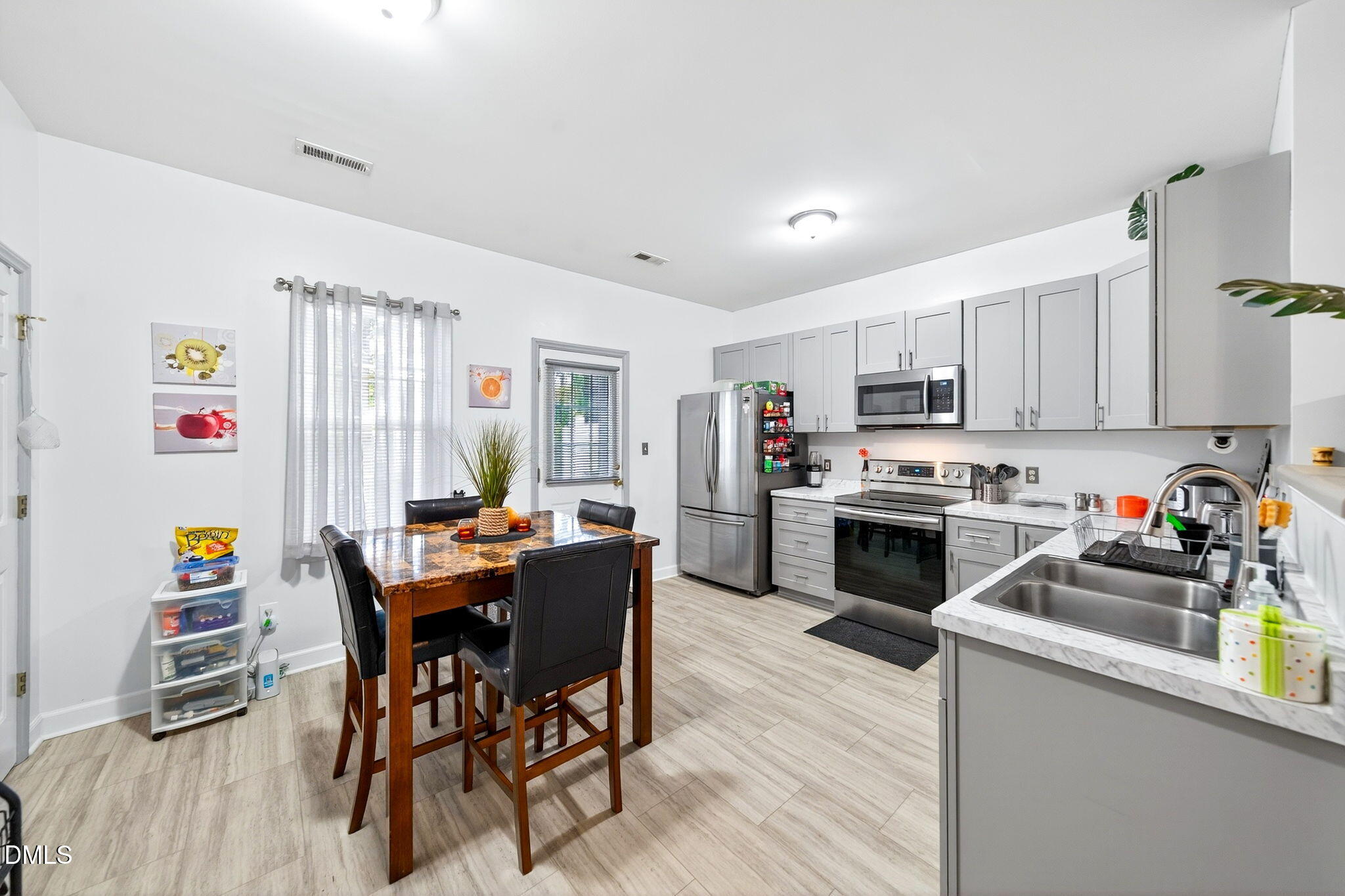 6010 San Marcos Way Raleigh, NC 27616 - Photo 8 of 22 a kitchen that has a lot of cabinets a sink and appliances in it