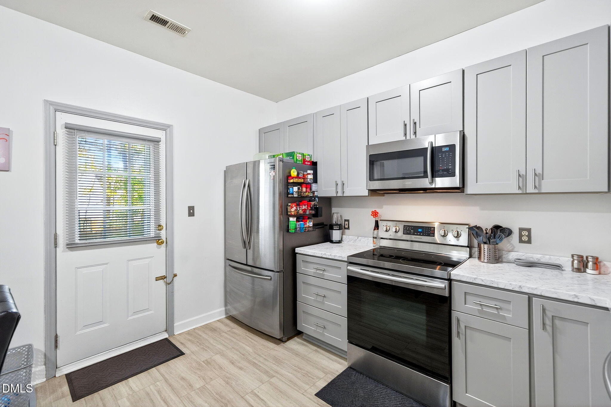 6010 San Marcos Way Raleigh, NC 27616 - Photo 9 of 22 a kitchen with stainless steel appliances granite countertop a refrigerator stove and sink