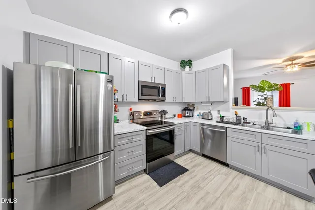a kitchen with a refrigerator sink and microwave