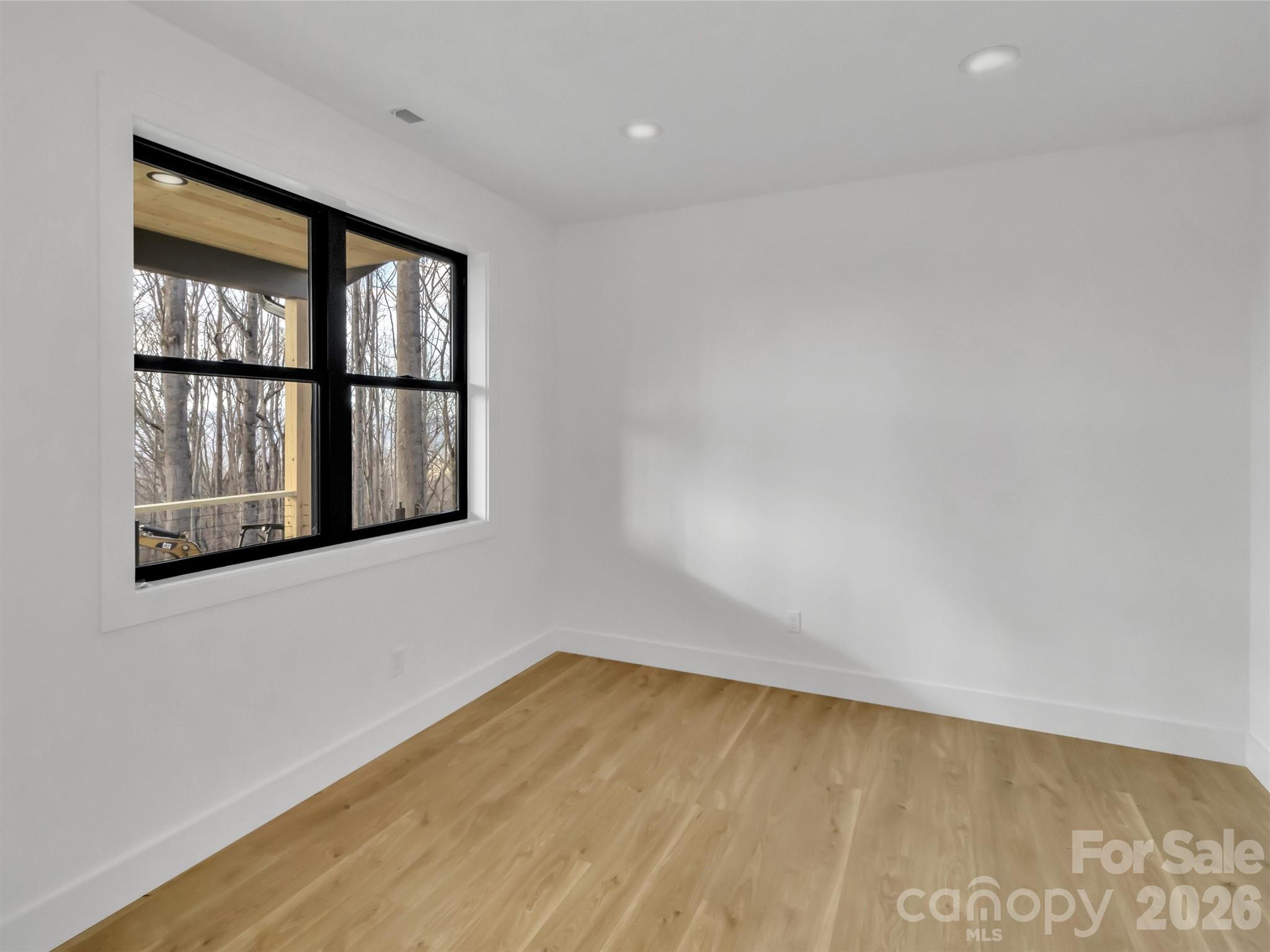 1351 Old Country Road Waynesville, NC 28786 - Photo 11 of 28 a view of empty room with wooden floor and fan
