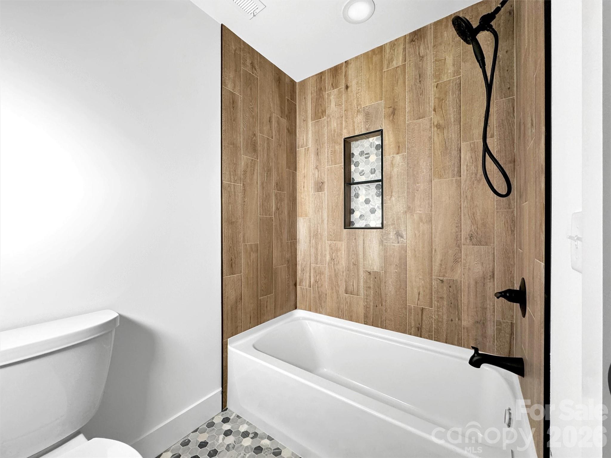 1351 Old Country Road Waynesville, NC 28786 - Photo 21 of 28 a bathroom with a toilet and a bathtub