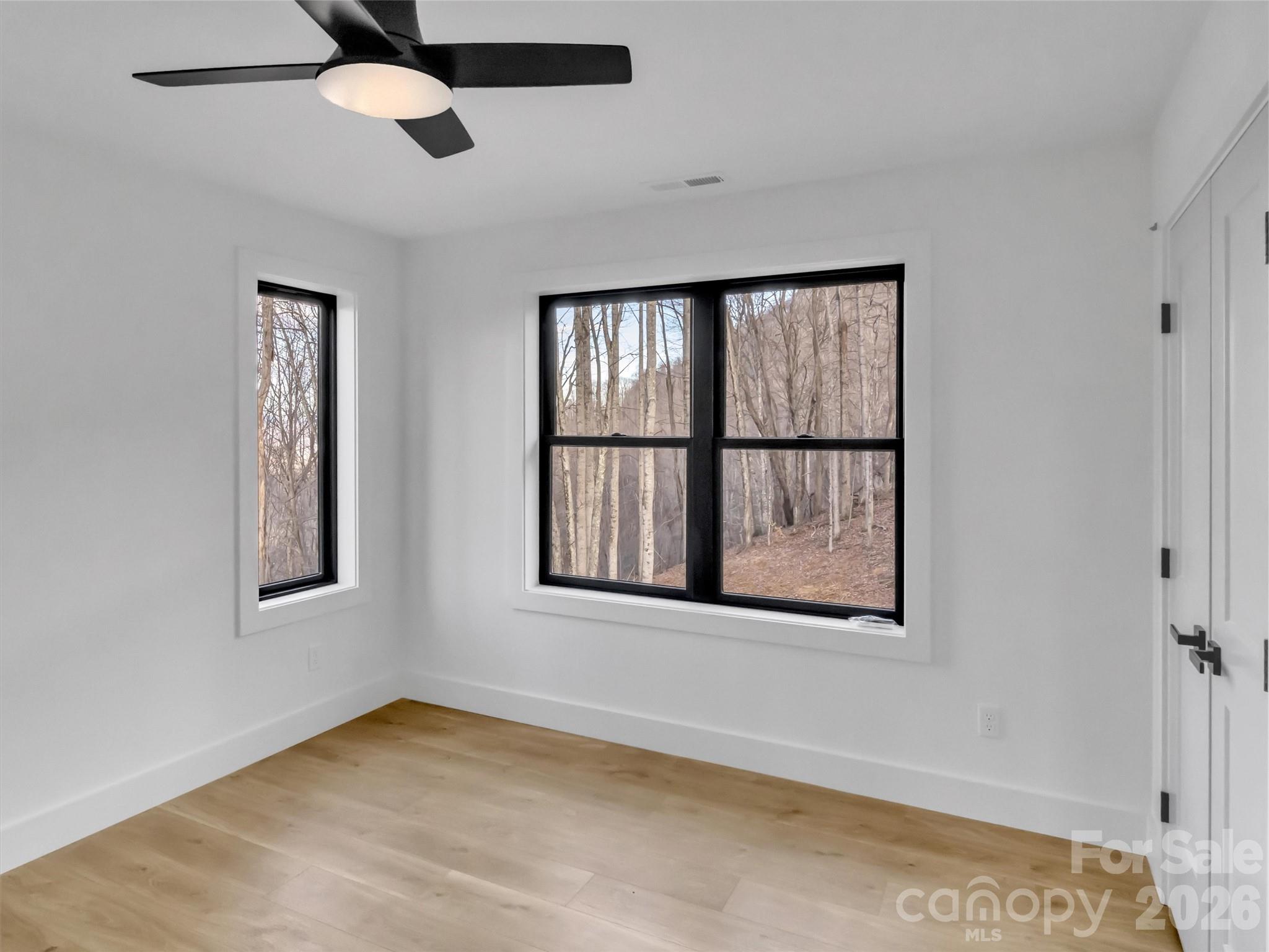 1351 Old Country Road Waynesville, NC 28786 - Photo 22 of 28 a view of an empty room with a window and a ceiling fan