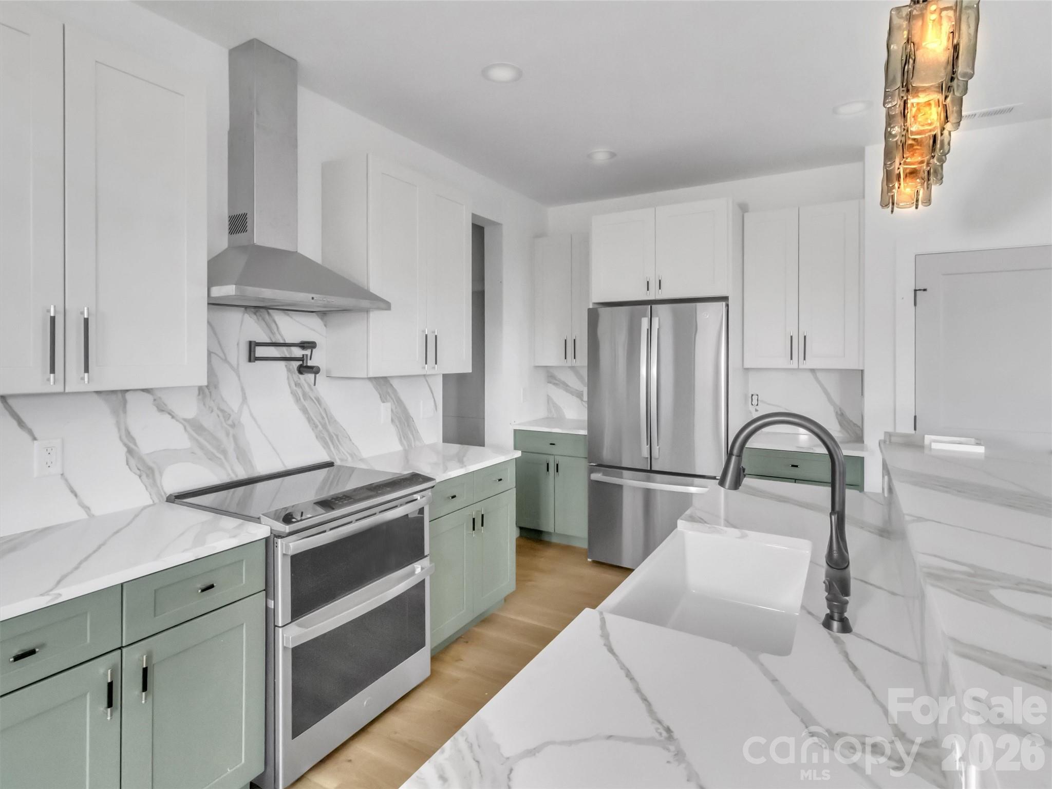 1351 Old Country Road Waynesville, NC 28786 - Photo 4 of 28 a kitchen with stainless steel appliances granite countertop a sink a stove a refrigerator and with a stove