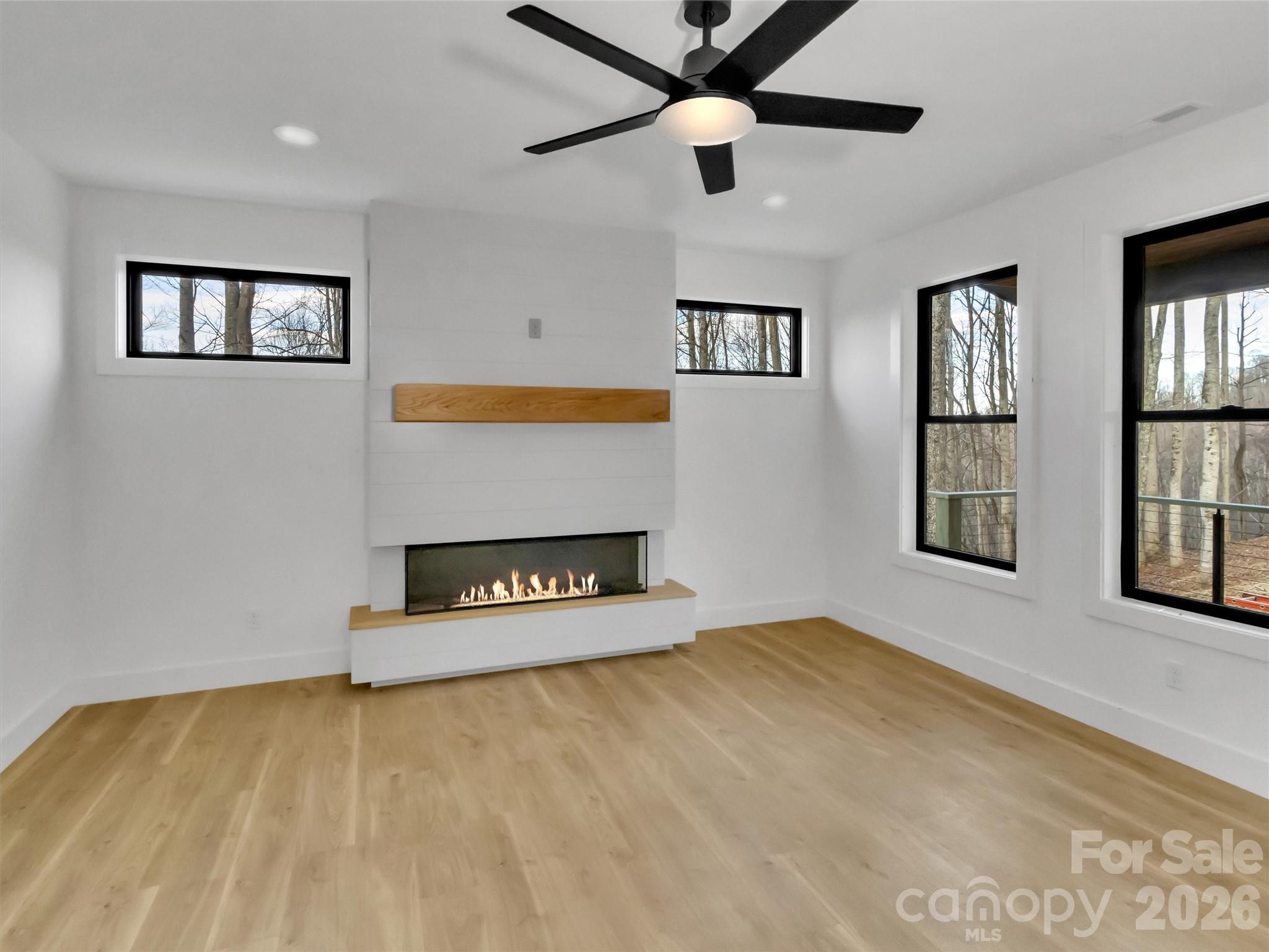 1351 Old Country Road Waynesville, NC 28786 - Photo 5 of 28 a view of an empty room with window and wooden floor