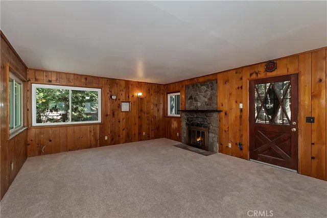 an empty room with furniture and a window