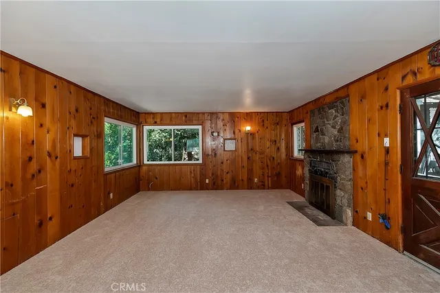 wooden floor in an empty room with a fireplace