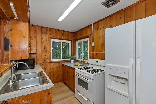 a kitchen with granite countertop a sink and a stove top oven