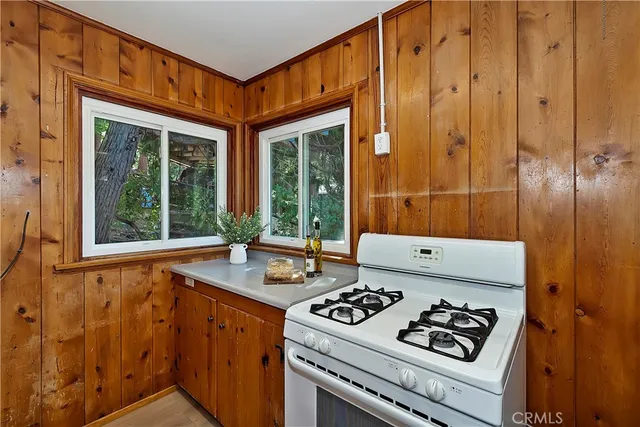 a kitchen with a stove and a window
