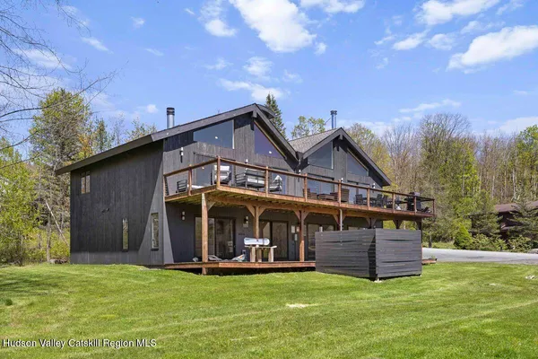 a view of a house with a yard balcony and sitting area