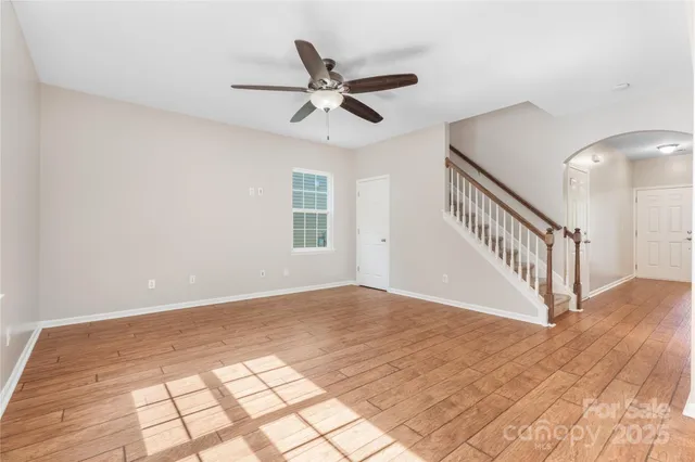 a view of a livingroom with a ceiling fan and window