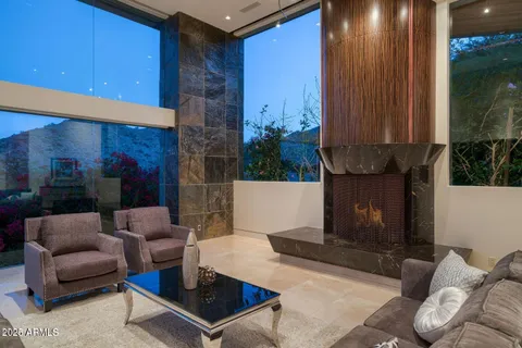 a kitchen with granite countertop a sink and chairs