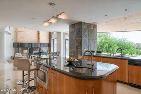a kitchen with granite countertop stainless steel appliances and wooden cabinets