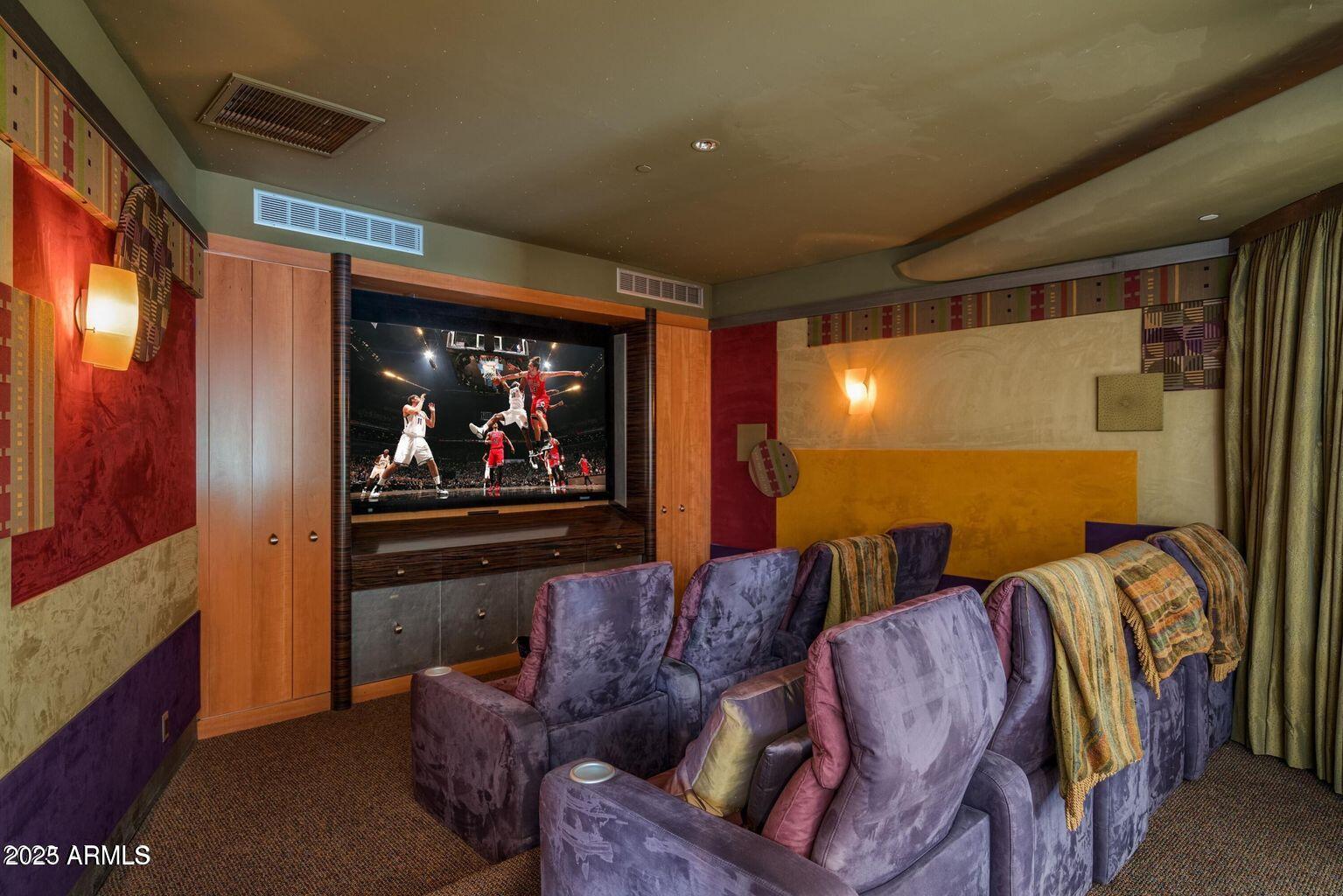4550 East Foothill Drive Paradise Valley, AZ 85253 - Photo 23 of 58 a living room with furniture a projector and a flat screen tv