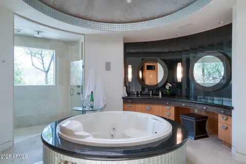 a living room with a flat screen tv and a ceiling fan