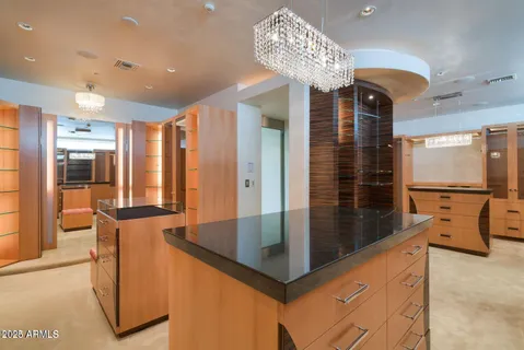 a bathroom with a granite countertop sink a toilet and a large mirror
