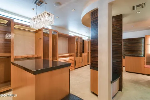 a view of a chandelier fan in an empty room