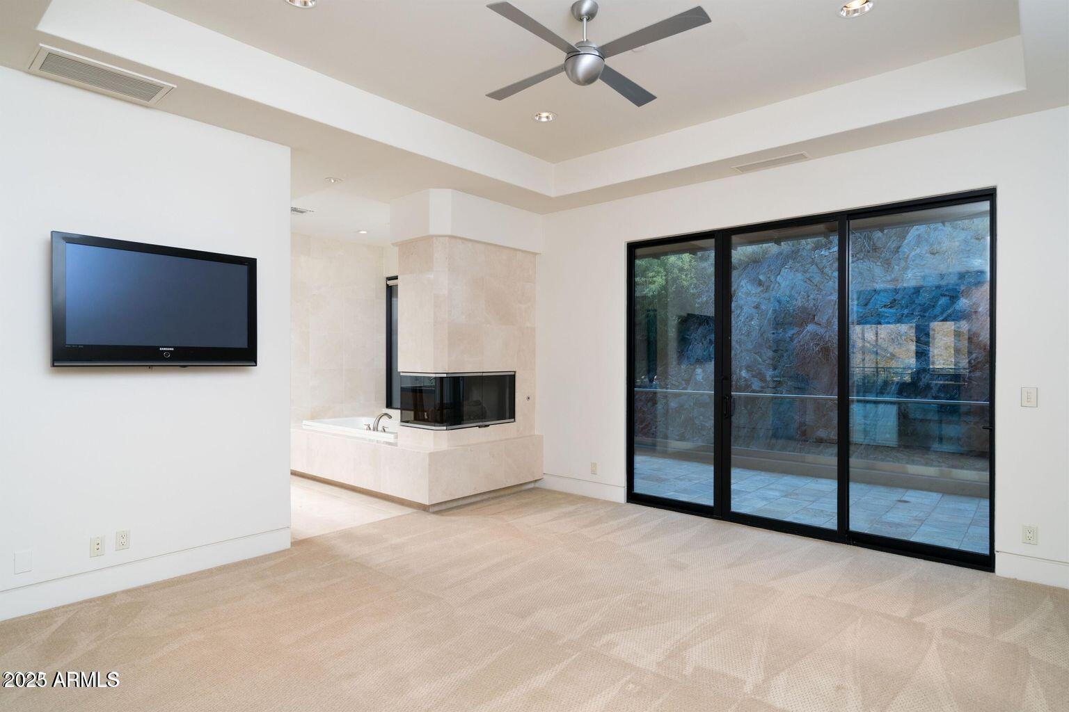 4550 East Foothill Drive Paradise Valley, AZ 85253 - Photo 41 of 58 a living room with a flat screen tv and a ceiling fan