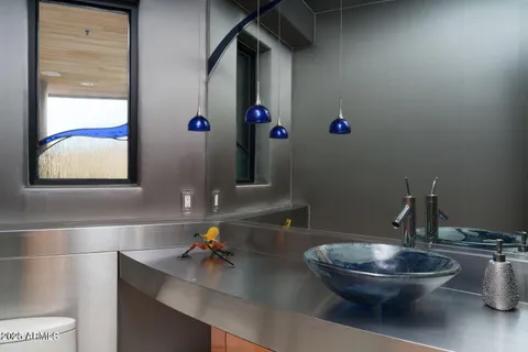 a view of a patio with couches table and chairs under an umbrella