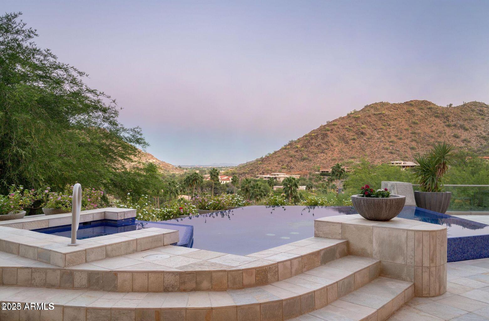 4550 East Foothill Drive Paradise Valley, AZ 85253 - Photo 56 of 58 a view of a patio with a dining table and chairs