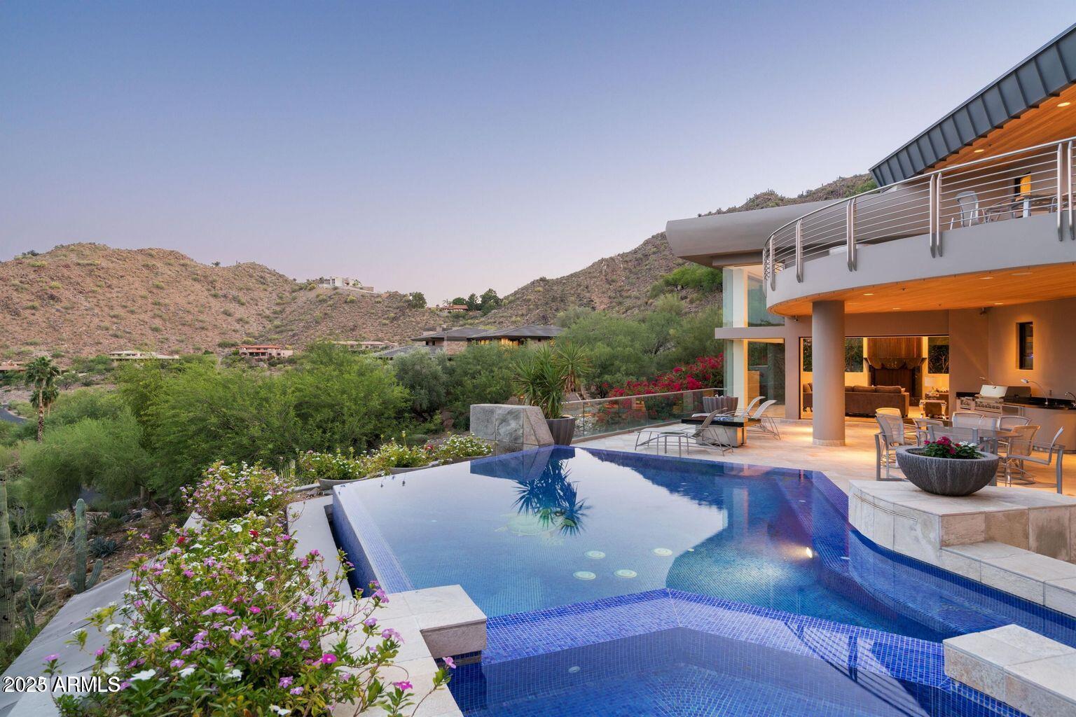 4550 East Foothill Drive Paradise Valley, AZ 85253 - Photo 57 of 58 a view of a patio with couches table and chairs under an umbrella