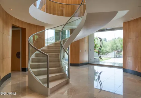 a living room with furniture and a floor to ceiling window