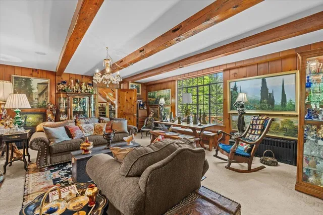 a living room with furniture and a chandelier