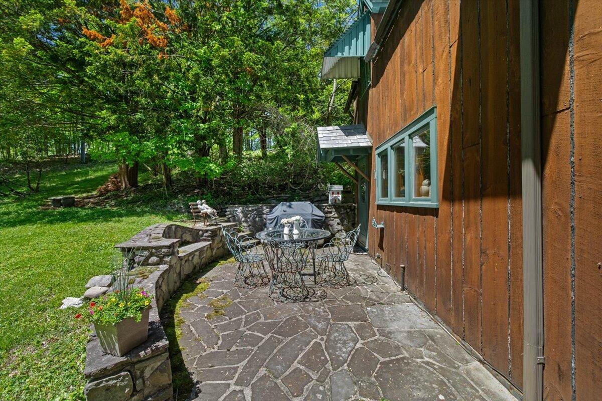 1341 Beaver Valley Road Stroudsburg, PA 18360 - Photo 28 of 84 a view of a patio with table and chairs and potted plants with wooden floor and fence