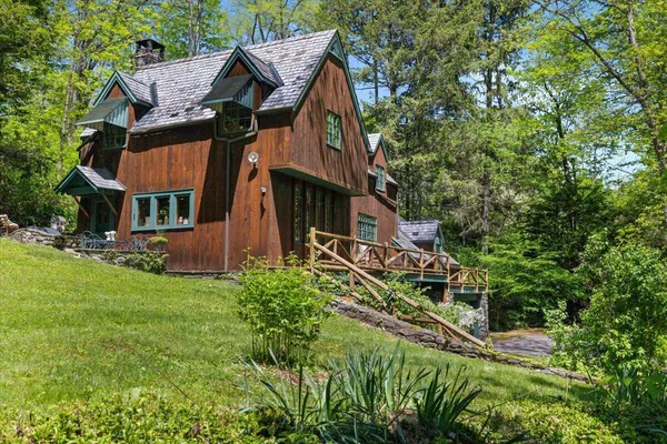 a view of a porch with chairs and backyard