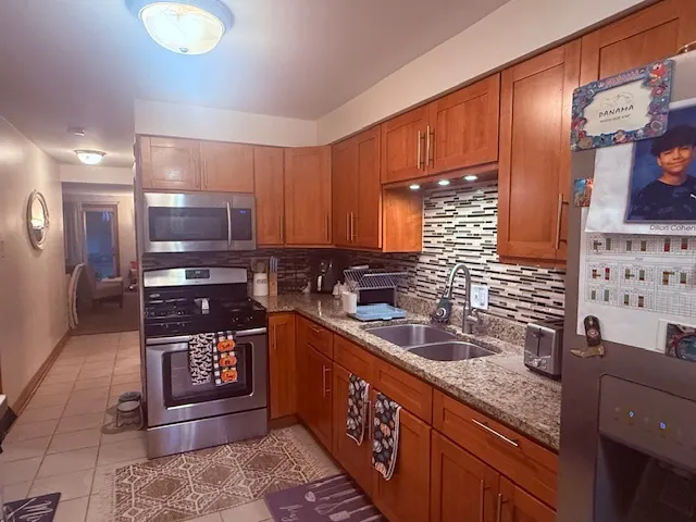 a kitchen with stainless steel appliances granite countertop a sink stove and cabinets