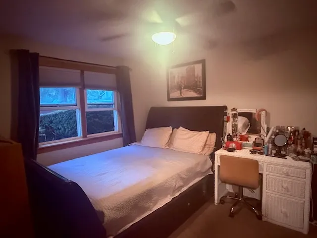 a bedroom with a bed and a window
