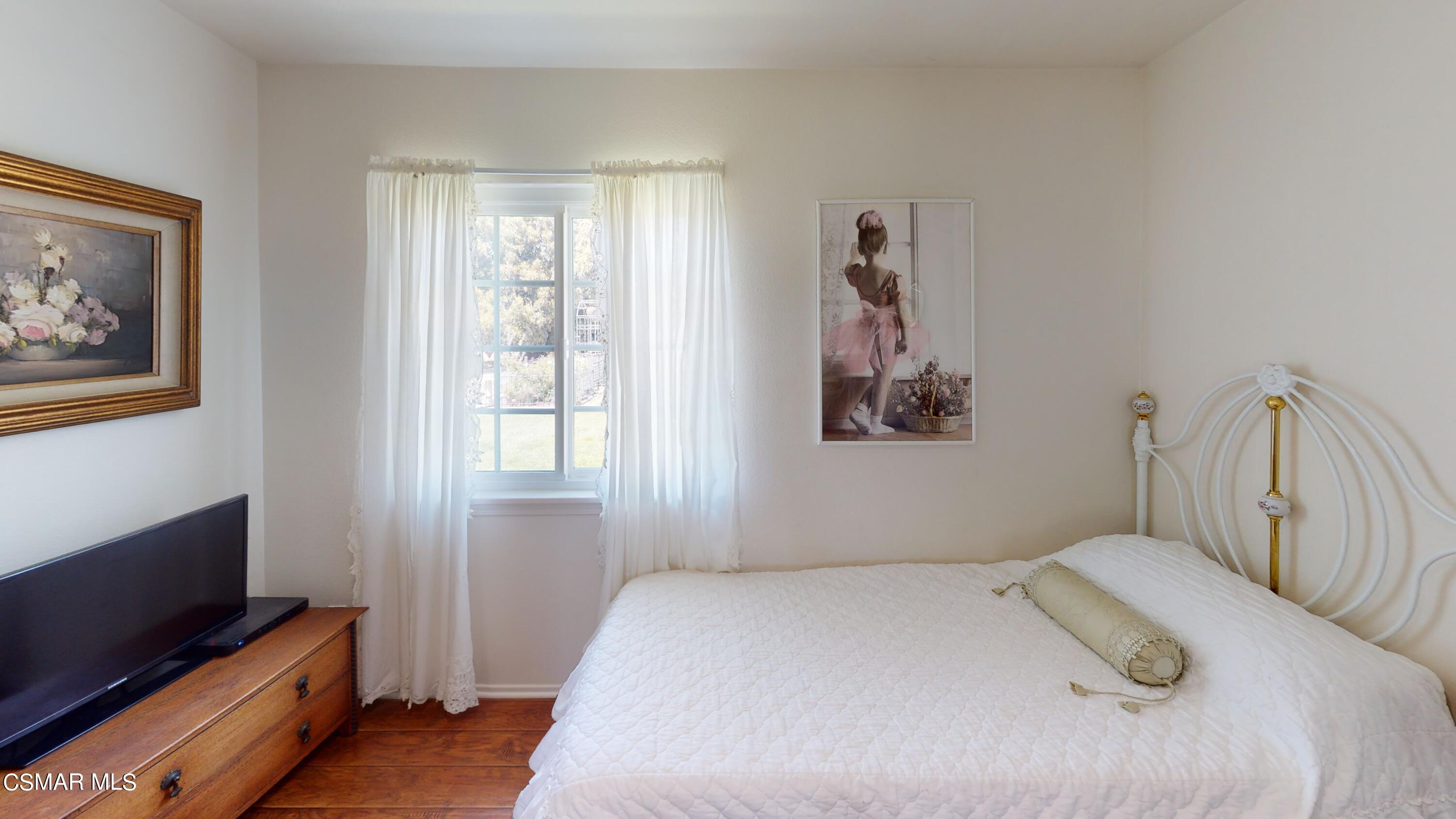 4865 Leeds Street Simi Valley, CA 93063 - Photo 28 of 91 a bedroom with a bed and a flat screen tv