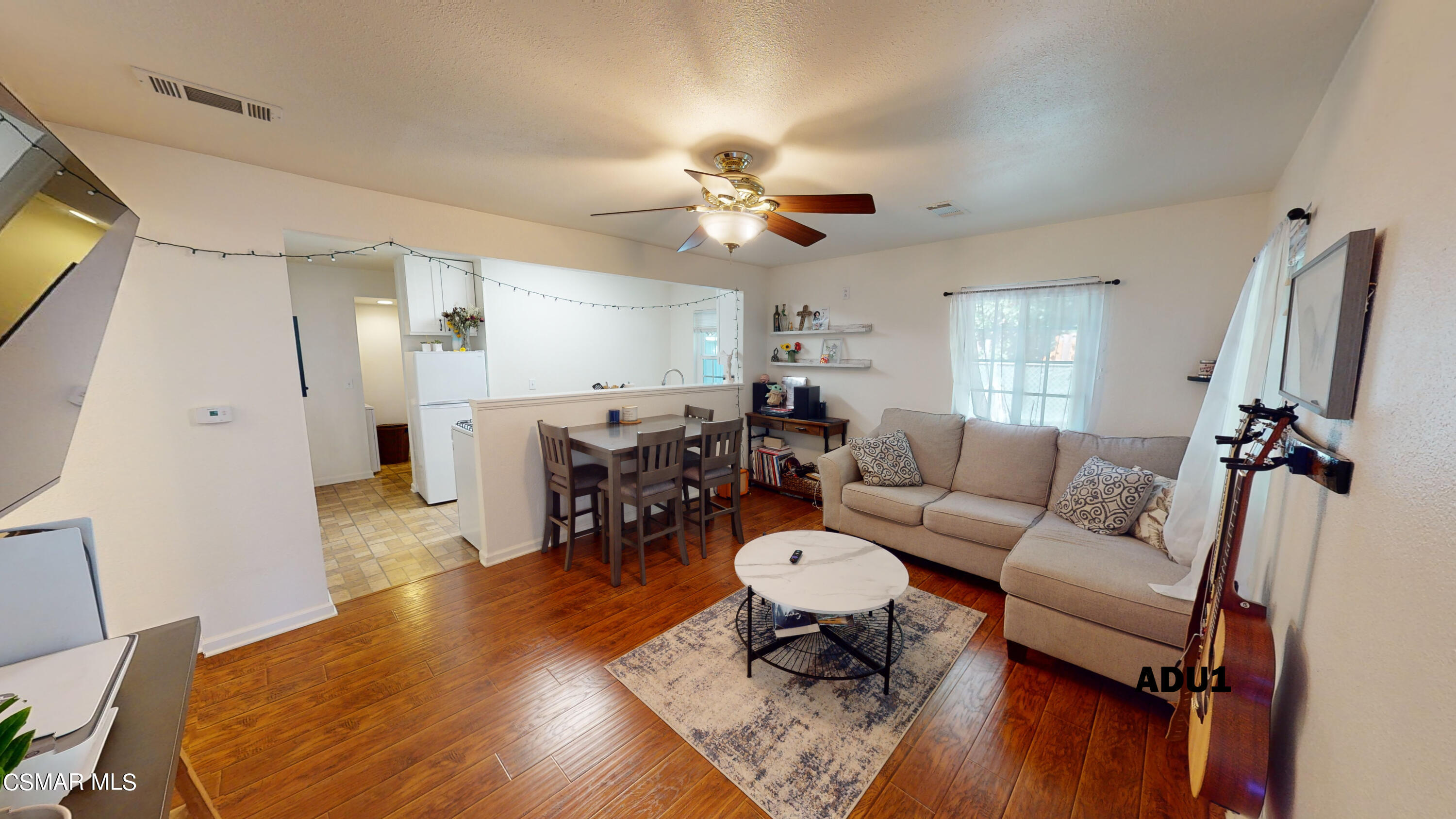 4865 Leeds Street Simi Valley, CA 93063 - Photo 46 of 91 a living room with furniture a chandelier and a flat screen tv