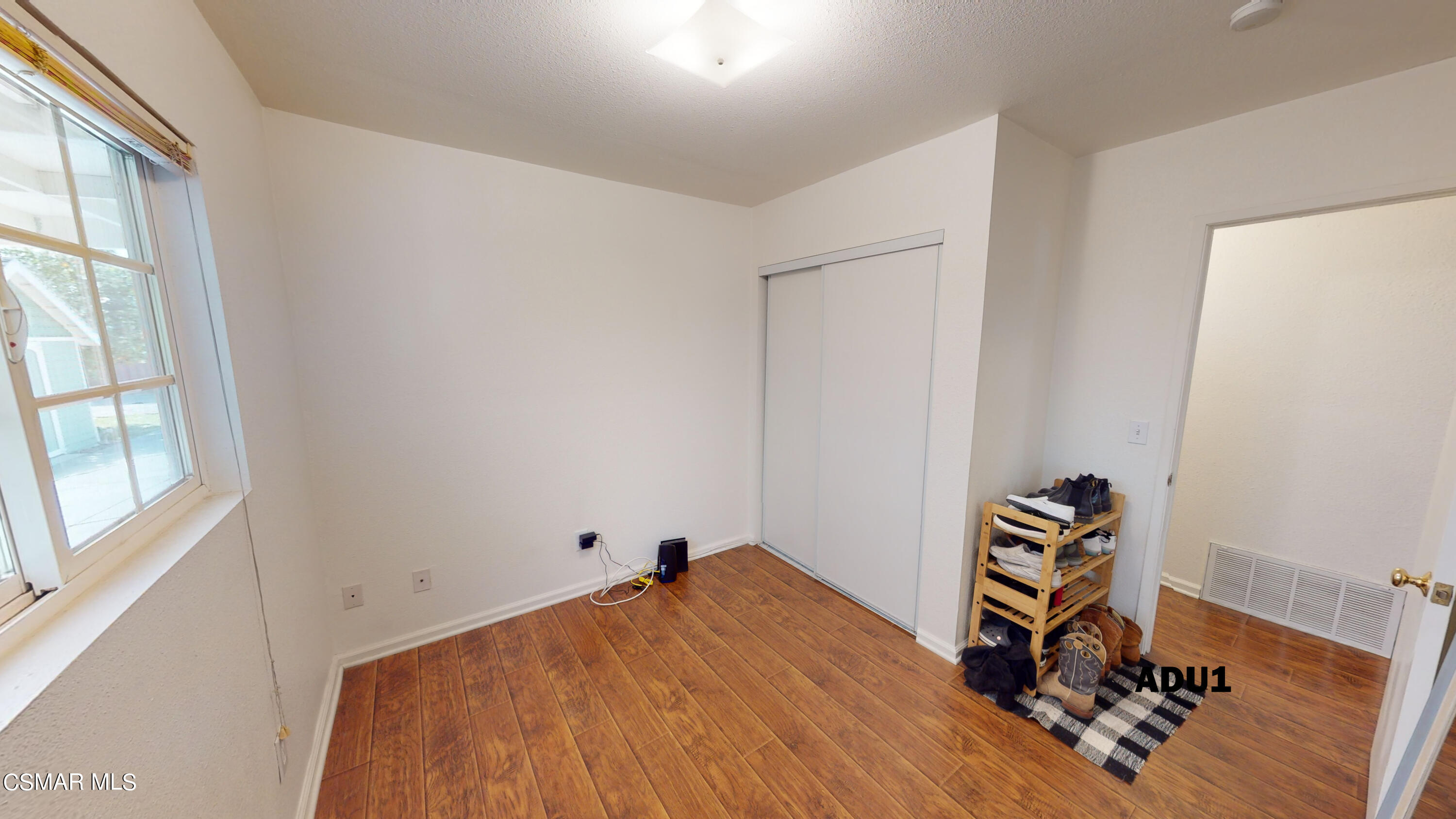 4865 Leeds Street Simi Valley, CA 93063 - Photo 51 of 91 a room with wooden floor and gym equipment