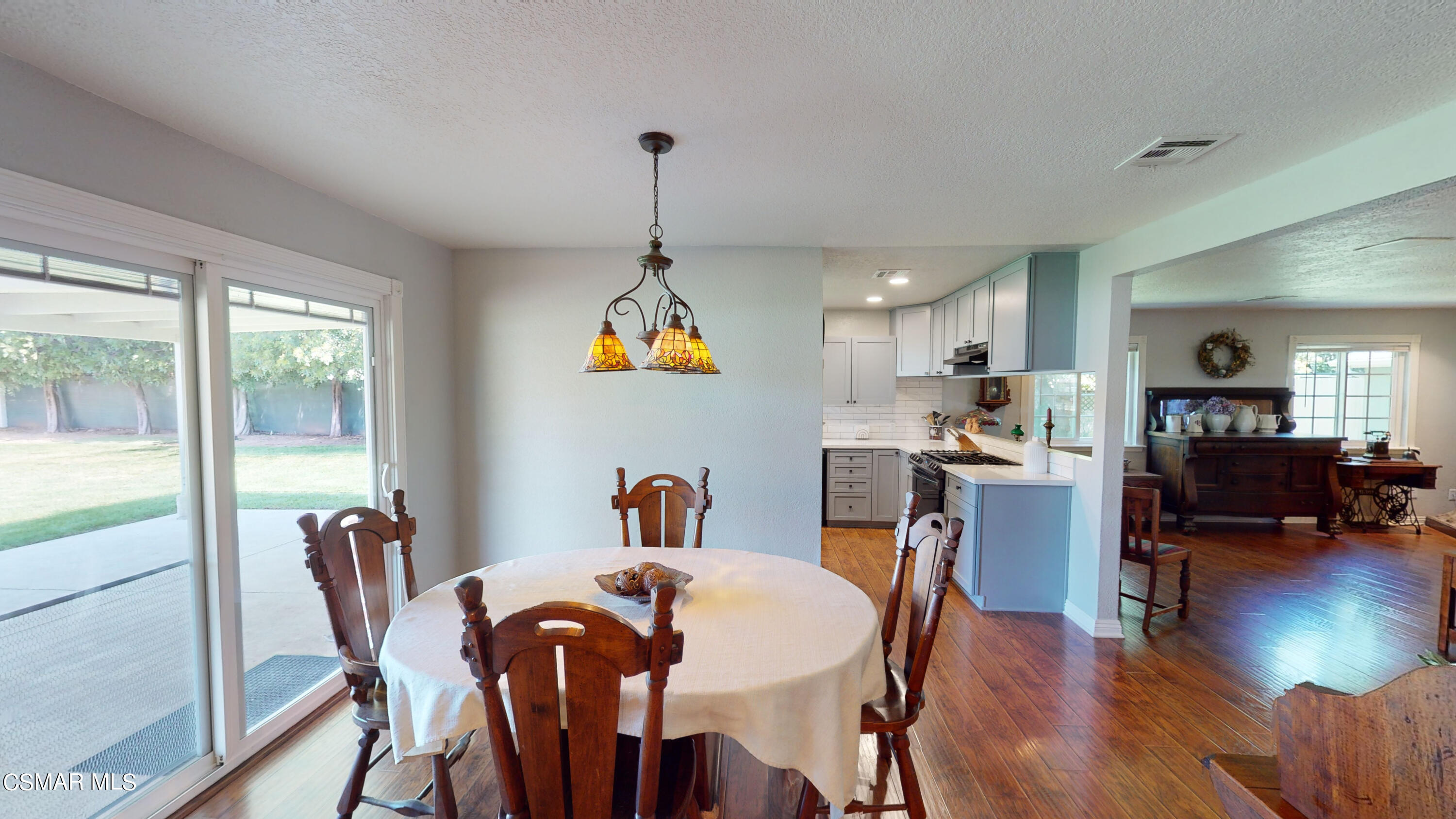 4865 Leeds Street Simi Valley, CA 93063 - Photo 10 of 91 a view of a dining room with furniture a chandelier and wooden floor