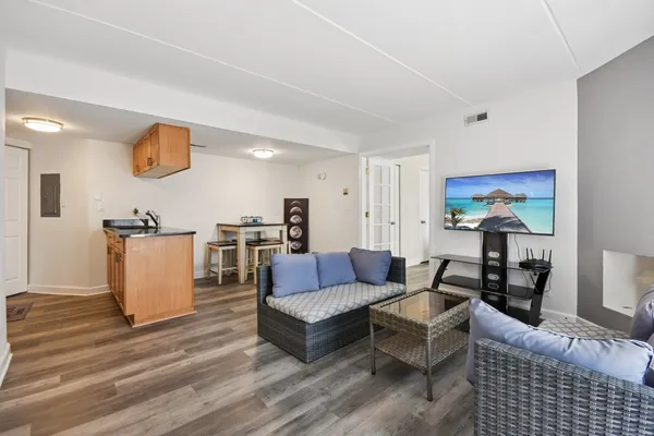 a living room with furniture and wooden floor