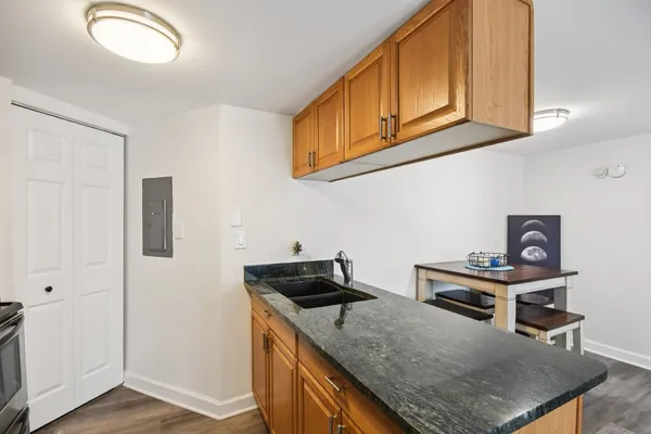 a kitchen with stainless steel appliances granite countertop a stove and a microwave
