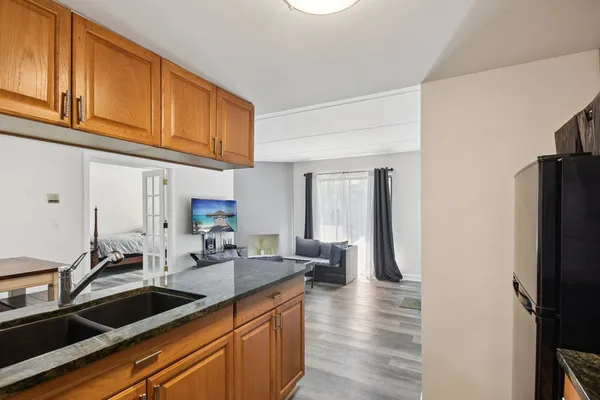 a kitchen with stainless steel appliances granite countertop a refrigerator and a sink