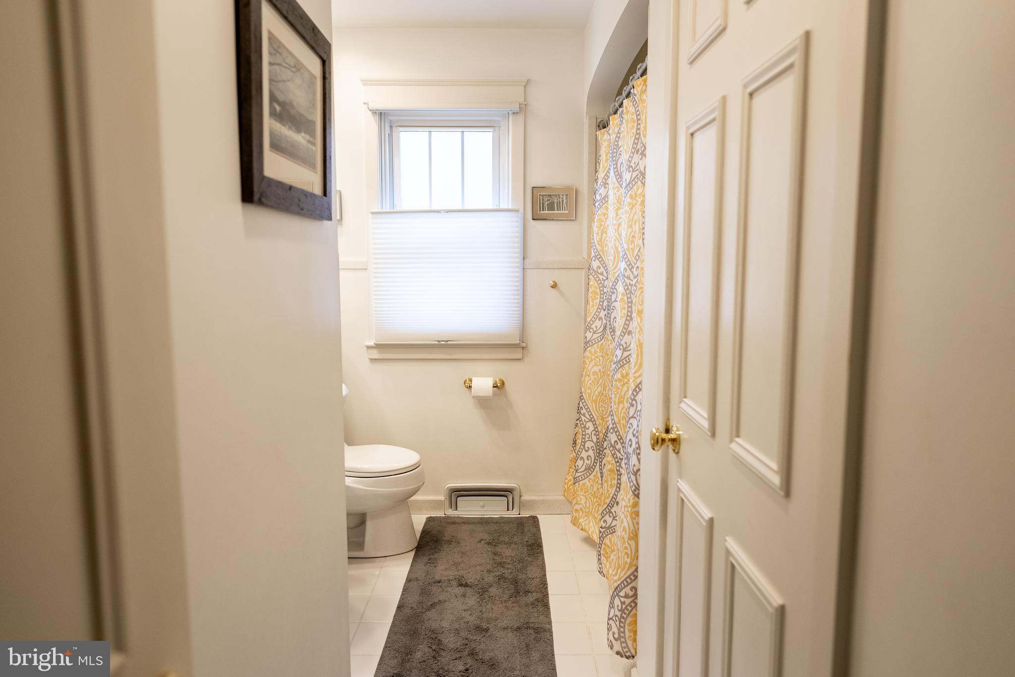 2188 Grandview Road Hanover, PA 17331 - Photo 17 of 37 a bathroom with a granite countertop sink a toilet and a window