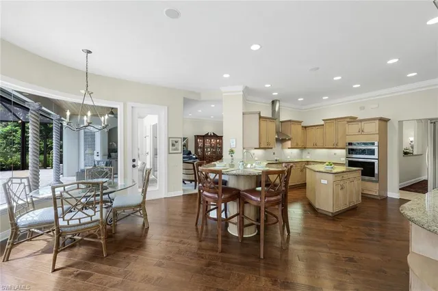 a large kitchen with a table and chairs