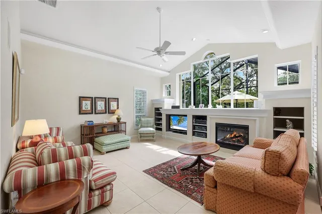 a living room with furniture fireplace and window