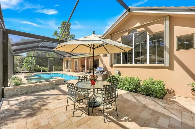 a view of a house with backyard sitting area and garden