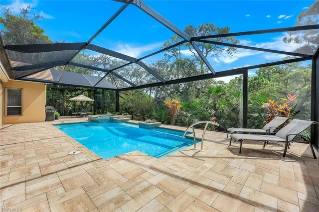 a view of patio with a table and chairs under an umbrella