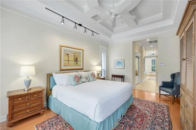 a bedroom with a bed and a chandelier