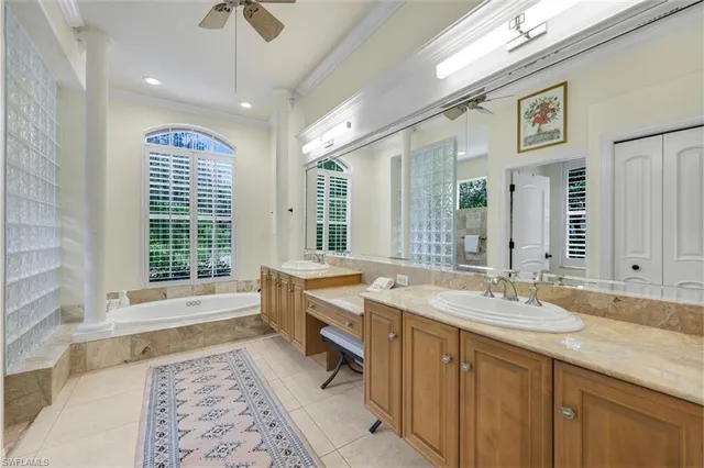 a spacious bathroom with a granite countertop tub sink and mirror