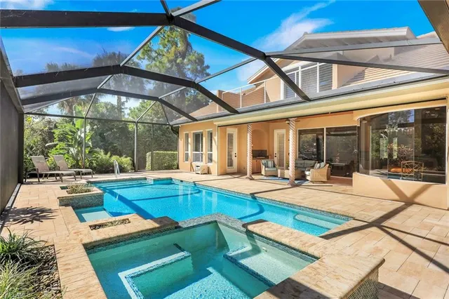 a view of a house with swimming pool and sitting area