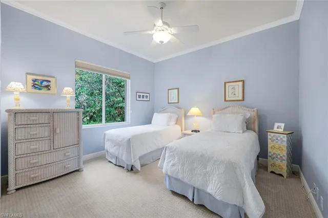 a bedroom with two beds and a dresser