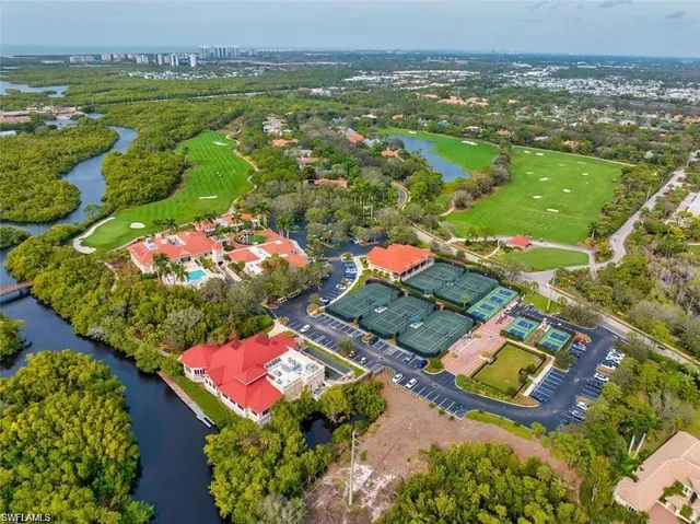 an aerial view of residential houses with outdoor space and river