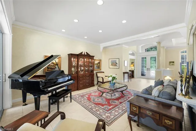 a living room with furniture and a piano