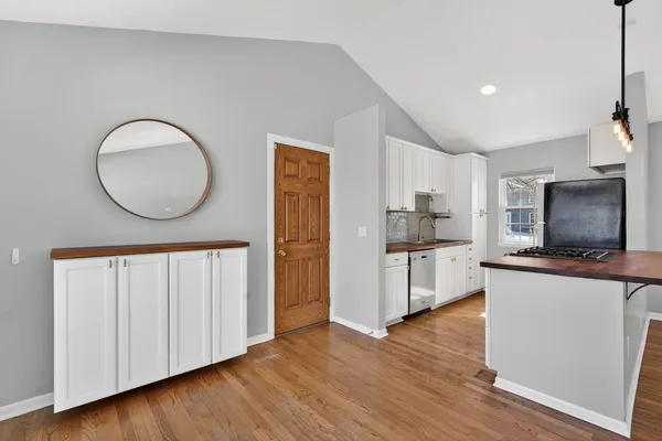 a kitchen with stainless steel appliances granite countertop a stove a sink a refrigerator and a microwave